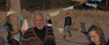 Movie still from “The Good Neighbor” (2022), directed by Stephan Rick – A man and a woman standing on a beach; Wide shot, Over the shoulder angle