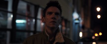 Movie still from “The Good Neighbor” (2022), directed by Stephan Rick – A person wearing a jacket; Close Up shot, Low angle