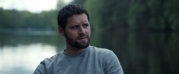 Movie still from “The Good Neighbor” (2022), directed by Stephan Rick – A person with a beard; Close Up shot, Over the shoulder angle