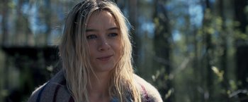 Movie still from “The Good Neighbor” (2022), directed by Stephan Rick – A person with long blonde hair; Close Up shot, Over the shoulder angle