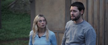 Movie still from “The Good Neighbor” (2022), directed by Stephan Rick – A man and a woman standing next to each other; Medium shot, Over the shoulder angle