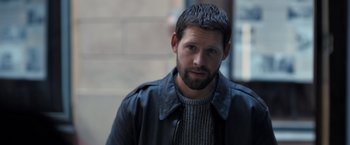 Movie still from “The Good Neighbor” (2022), directed by Stephan Rick – A person wearing a jacket; Close Up shot, High angle