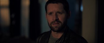 Movie still from “The Good Neighbor” (2022), directed by Stephan Rick – A person wearing a jacket; Close Up shot, Over the shoulder angle