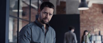 Movie still from “The Good Neighbor” (2022), directed by Stephan Rick – A person wearing a shirt; Close Up shot, Low angle