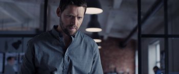 Movie still from “The Good Neighbor” (2022), directed by Stephan Rick – A person wearing a blue shirt; Close Up shot, Low angle