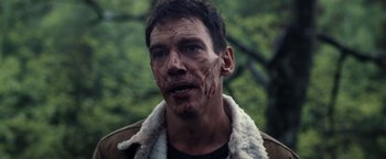 Movie still from “The Good Neighbor” (2022), directed by Stephan Rick – A person with blood on his face; Close Up shot, Over the shoulder angle