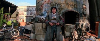 Movie still from “The Goonies” (1985), directed by Richard Donner – A person standing in front of an old building; Medium shot, Low angle