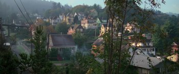 Movie still from “The Goonies” (1985), directed by Richard Donner – A view of a small town from a hill; Extreme Wide shot, High angle
