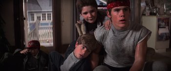 Movie still from “The Goonies” (1985), directed by Richard Donner – A group of young people posing for a picture; Medium shot, Low angle