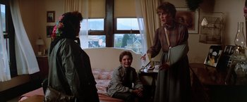 Movie still from “The Goonies” (1985), directed by Richard Donner – A group of people standing in a room with a window; Medium shot, Over the shoulder angle