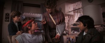 Movie still from “The Goonies” (1985), directed by Richard Donner – A young boy and a young woman in a room; Medium shot, Over the shoulder angle