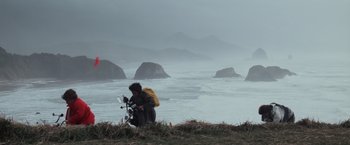 Movie still from “The Goonies” (1985), directed by Richard Donner – A man standing on top of a grass covered hill; Extreme Wide shot, Low angle