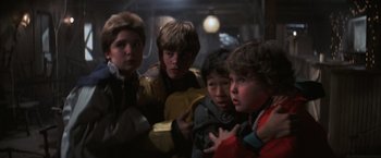 Movie still from “The Goonies” (1985), directed by Richard Donner – A group of young people standing next to each other; Medium shot, Low angle