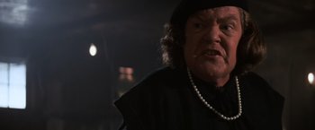 Movie still from “The Goonies” (1985), directed by Richard Donner – An old man with a beard and a hat and a necklace; Close Up shot, Over the shoulder angle