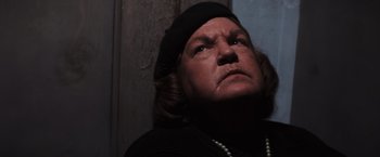Movie still from “The Goonies” (1985), directed by Richard Donner – An older woman wearing a black hat and pearls; Close Up shot, Low angle