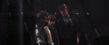 Movie still from “The Goonies” (1985), directed by Richard Donner – A group of young men standing next to each other; Medium shot, Low angle