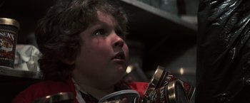 Movie still from “The Goonies” (1985), directed by Richard Donner – A young boy is holding a can and looking up; Close Up shot, Low angle