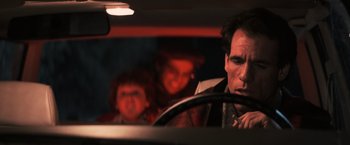 Movie still from “The Goonies” (1985), directed by Richard Donner – A man sitting in the drivers seat of a car; Close Up shot, Over the shoulder angle