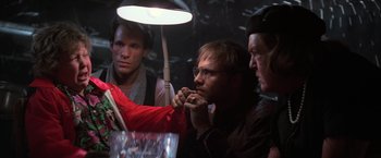 Movie still from “The Goonies” (1985), directed by Richard Donner – A group of people sitting around a table; Close Up shot, Over the shoulder angle