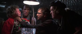 Movie still from “The Goonies” (1985), directed by Richard Donner – A group of men standing around a light; Close Up shot, Over the shoulder angle