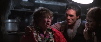 Movie still from “The Goonies” (1985), directed by Richard Donner – A man and a woman are crying in a dark room; Close Up shot, Over the shoulder angle