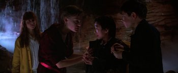 Movie still from “The Goonies” (1985), directed by Richard Donner – A group of people standing next to each other in a room; Medium shot, Over the shoulder angle