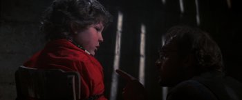 Movie still from “The Goonies” (1985), directed by Richard Donner – A young child and an older man are looking at each other; Medium shot, Over the shoulder angle