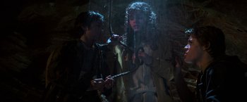 Movie still from “The Goonies” (1985), directed by Richard Donner – A man and a woman are holding a rope; Medium shot, Overhead angle