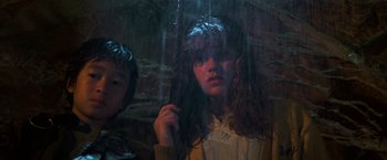 Movie still from “The Goonies” (1985), directed by Richard Donner – A young girl holding onto an umbrella in the rain; Close Up shot, Low angle