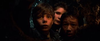 Movie still from “The Goonies” (1985), directed by Richard Donner – A group of young men standing next to each other in the dark; Close Up shot, Low angle