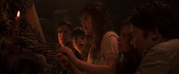 Movie still from “The Goonies” (1985), directed by Richard Donner – A group of young people looking at a cell phone; Close Up shot, Low angle