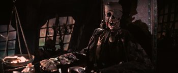 Movie still from “The Goonies” (1985), directed by Richard Donner – A skeleton wearing a bandanna sitting on a chair; Close Up shot, Low angle