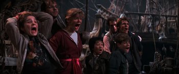 Movie still from “The Goonies” (1985), directed by Richard Donner – A group of people standing next to each other; Medium shot, High angle