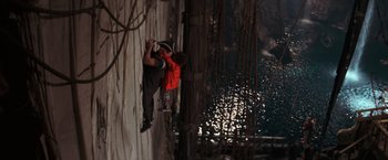 Movie still from “The Goonies” (1985), directed by Richard Donner – A man climbing up the side of a building; Extreme Wide shot, Overhead angle