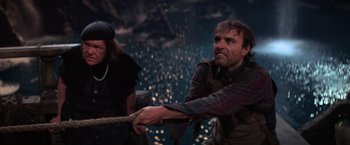 Movie still from “The Goonies” (1985), directed by Richard Donner – A man pulling a rope while another man watches; Medium shot, High angle