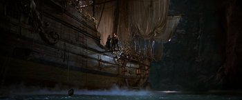 Movie still from “The Goonies” (1985), directed by Richard Donner – Two men standing on the side of a boat; Extreme Wide shot, Low angle
