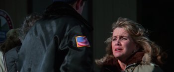 Movie still from “The Goonies” (1985), directed by Richard Donner – A woman is crying while a man is standing next to her; Close Up shot, Over the shoulder angle