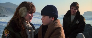 Movie still from “The Goonies” (1985), directed by Richard Donner – Two people standing next to each other near the ocean; Close Up shot, Over the shoulder angle