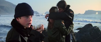 Movie still from “The Goonies” (1985), directed by Richard Donner – A group of young people hugging near the ocean; Close Up shot, Over the shoulder angle