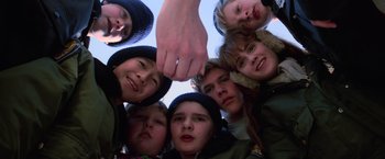 Movie still from “The Goonies” (1985), directed by Richard Donner – A group of children holding hands in a circle; Close Up shot, Low angle