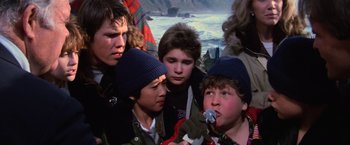 Movie still from “The Goonies” (1985), directed by Richard Donner – A group of young people standing next to each other on a boat; Close Up shot, Low angle