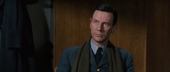 Movie still from “The Great Escape” (1963), directed by John Sturges – A man wearing a suit and a scarf; Close Up shot, Over the shoulder angle