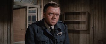 Movie still from “The Great Escape” (1963), directed by John Sturges – An older man in a military uniform looking to his left; Close Up shot, Low angle