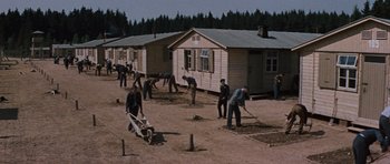 Movie still from “The Great Escape” (1963), directed by John Sturges – A group of men working on a field; Extreme Wide shot, High angle