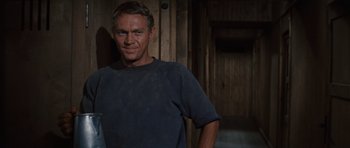 Movie still from “The Great Escape” (1963), directed by John Sturges – A person standing in a room; Medium shot, Over the shoulder angle