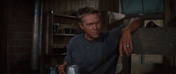 Movie still from “The Great Escape” (1963), directed by John Sturges – A man holding a cup in his hand; Close Up shot, Low angle
