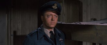 Movie still from “The Great Escape” (1963), directed by John Sturges – A man wearing a uniform and wearing a hat; Close Up shot, Low angle