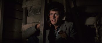 Movie still from “The Great Escape” (1963), directed by John Sturges – A man in a hat holding a knife in his hand; Close Up shot, Overhead angle