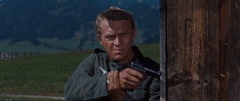 Movie still from “The Great Escape” (1963), directed by John Sturges – A person holding a gun; Close Up shot, Low angle