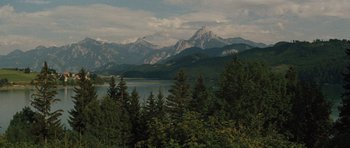 Movie still from “The Great Escape” (1963), directed by John Sturges – A view of a mountain range with a body of water in the foreground; Extreme Wide shot, High angle